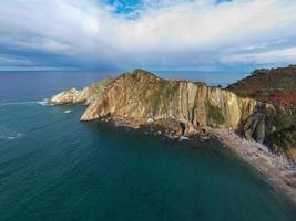 Silence beach, silver-sandy cove backed by a natural rock amphitheatre in Asturias, Spain.