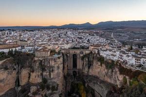 Rocky landscape of Ronda city with Puente Nuevo Bridge and buildings, Andalusia, Spain photo