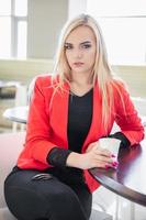 Adorable young blonde posing in a cafe photo