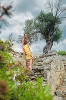 Cute lady posing among antique ruins photo