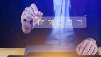 Businessman tick correct sign mark for document approve , project acceptance and quality assurance concept, take an assessment, questionnaire, evaluation, online survey online exam check list photo