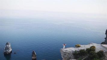 Tourist woman outdoor on edge of cliff seashore video