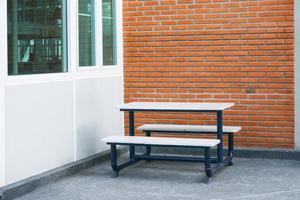 Bench in front of a brick wall blocks at modern building photo