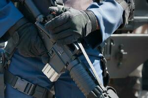 Soldier holding a machine with automatic gun.Preparation for military action.Soldier dressed in protective equipment photo