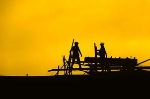 Silhouette of engineer and construction team working at site for industry background,Workers are working silhouette photo