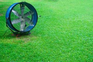 Large round powerful industrial professional metal iron fan with louvres at garden photo