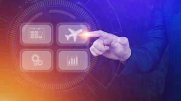 Businessman pointing finger touching to select flight by pressing touch screen airplane button,Business Airplane transportation concept photo