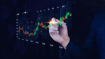 Businessman touch points symbol stock graph and chart background, concept growth and development business investment, Stock market and strategy making market plan and stock market fluctuations photo