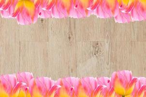 Tulips, frame  Fresh spring tulips flowers with space for text  on wooden background photo