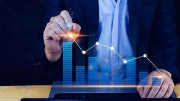 Businessman touch points symbol stock graph and chart background, concept growth and development business investment, Stock market and strategy making market plan and stock market fluctuations photo