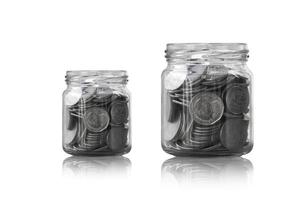 coins in a glass jar against ,savings coins - Investment And Interest Concept saving money concept, growing money on piggy bank. isolated on white background photo