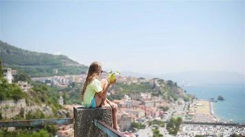 Big yellow lemon in hand in background of mediterranean sea and sky. video