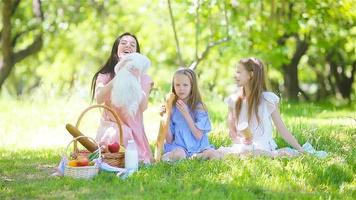 Happy mother and little daughers relax by the lake video