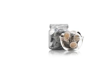 coins in a glass jar against ,savings coins - Investment And Interest Concept saving money concept, growing money on piggy bank. isolated on white background photo