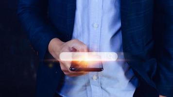 Businessman touching smartphone data search box information technology Search Engine Optimization. uses a search box to search for information on the Internet. photo
