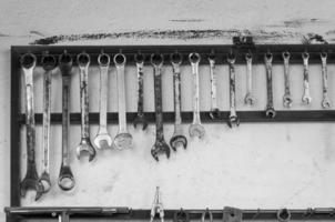 Set of wrenches tools hanging on a wall In a tool shed or workshop photo