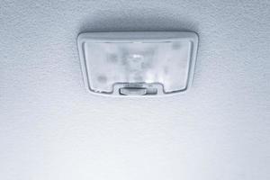 Light at roof in modern car, switch of light, lamp photo