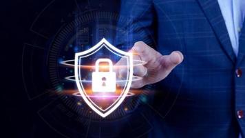 Computer network protection, secure and safe your data concept, businessman holding shield protection icon, Security shield Lock Security Businessman Protect Concept photo
