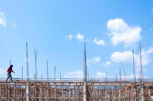 Construction site view of scaffolding poles on building site,construction worker on construction site photo