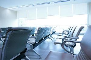 Row of empty seats in airport lobby,An empty row of chair at airport photo