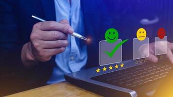 Businessman choosing happy smile face icon. feedback rating and positive customer review experience, satisfaction survey. mental health assessment. photo