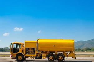 yellow truck with fuel tank on runway photo