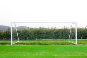 Goal shot from the corner in the front ,soccer field,empty amateur football goal posts and nets photo