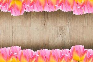 Tulips, frame  Fresh spring tulips flowers with space for text  on wooden background photo