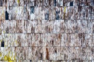 exposed old wooden wall exterior, patchwork of raw wood forming a beautiful parquet wood pattern photo