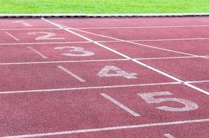 Numbers starting point on red running track,running track and green grass,Direct athletics Running track at Sport Stadium photo