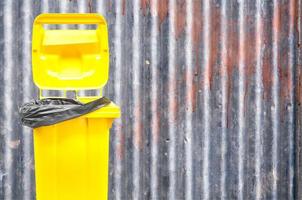 yellow bin on background old  Zinc textured photo