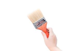 Woman hand with paint brush with wooden handle on a white background photo