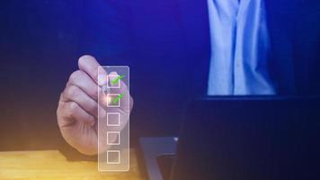 Businessman tick correct sign mark for document approve , project acceptance and quality assurance concept, take an assessment, questionnaire, evaluation, online survey online exam check list photo