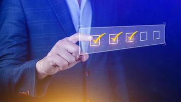 Businessman tick correct sign mark for document approve , project acceptance and quality assurance concept, take an assessment, questionnaire, evaluation, online survey online exam check list photo
