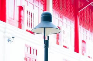 Street lamp retro on traditional red door wooden  background photo