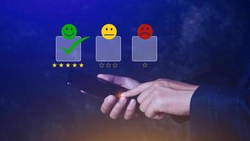 Customer service evaluation concept feedback rating and positive customer review experience, using a smartphone And pressing face emoticon smile in satisfaction on virtual touch screen photo