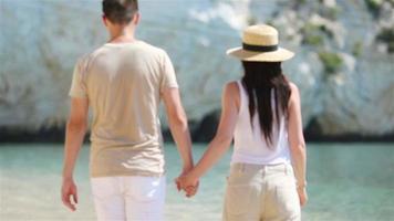 Young couple on white beach during summer vacation. video