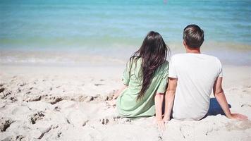 Young couple on white beach during summer vacation. video