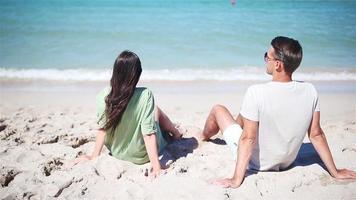 Young couple on white beach during summer vacation. video