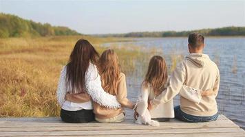 Beautiful family at autumn warm day near lake video