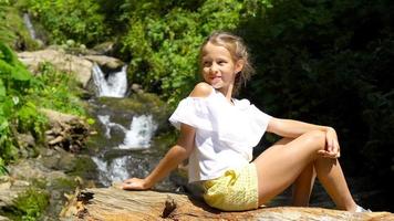 Little girl enjoying view of waterfall in Krasnay Poliana video