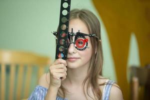 A girl in special glasses for the treatment of vision problems. photo