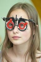 A girl in special glasses for the treatment of vision problems. photo