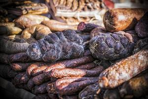 An outdoor stall with a bunch of homemade sausages for sale photo