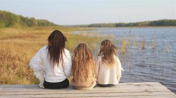 Beautiful family at autumn warm day near lake video