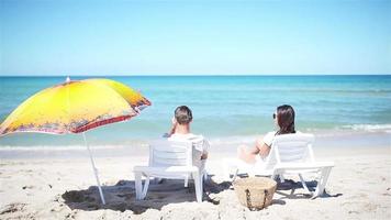 Young couple on white beach during summer vacation. video