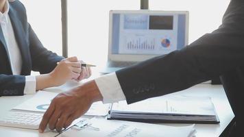 Financial analysts analyze business financial reports on a digital tablet planning investment project during a discussion at a meeting of corporate showing the results of their successful teamwork. video