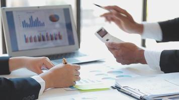 Financial analysts analyze business financial reports on a digital tablet planning investment project during a discussion at a meeting of corporate showing the results of their successful teamwork. video