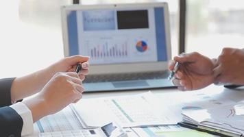 Financial analysts analyze business financial reports on a digital tablet planning investment project during a discussion at a meeting of corporate showing the results of their successful teamwork. video