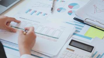 Financial analysts analyze business financial reports on a digital tablet planning investment project during a discussion at a meeting of corporate showing the results of their successful teamwork. video